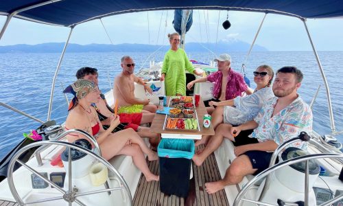 Famil enjoys a meal with vegan options on a private day cruise to Ammouliani island and Mount Athos
