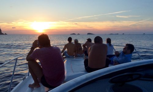 A group of friends relaxing on the spacious deck of our motor yacht and enjoying the view during a private luxury sunset cruise in Halkidiki