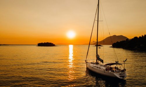 Bavaria 46ft sailboat anchored near Diaporos island during a sailing sunset cruise